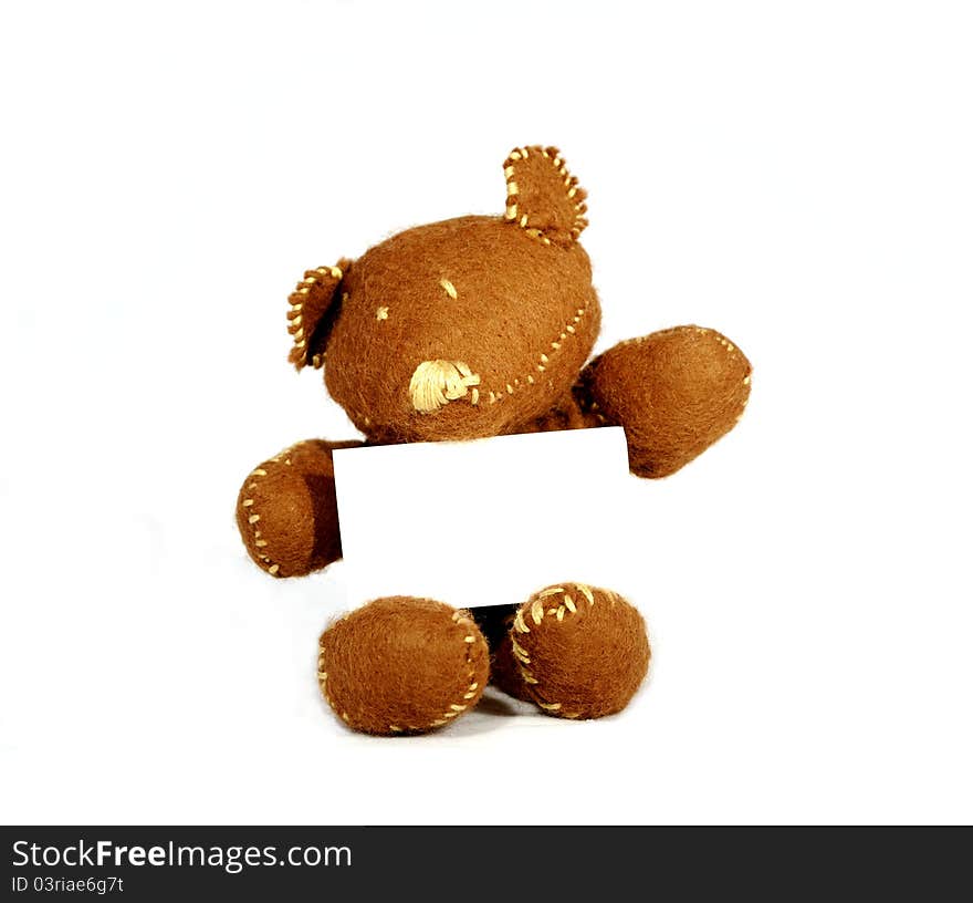 Brown teddy holding white card in white background. Brown teddy holding white card in white background