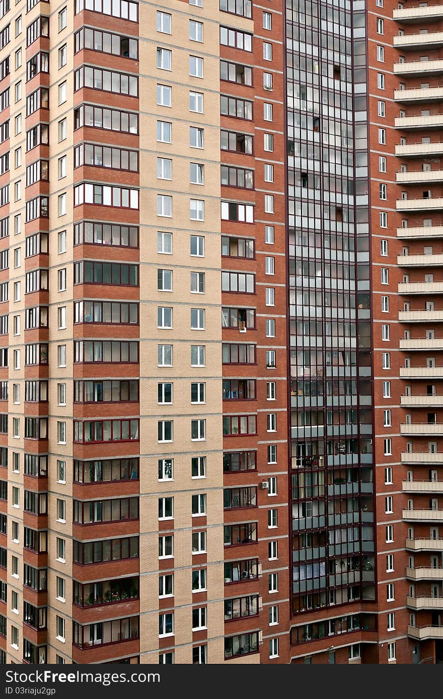 Multi-storey brick house with windows and balconies