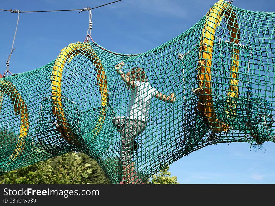 The child passes through the mesh. Playground