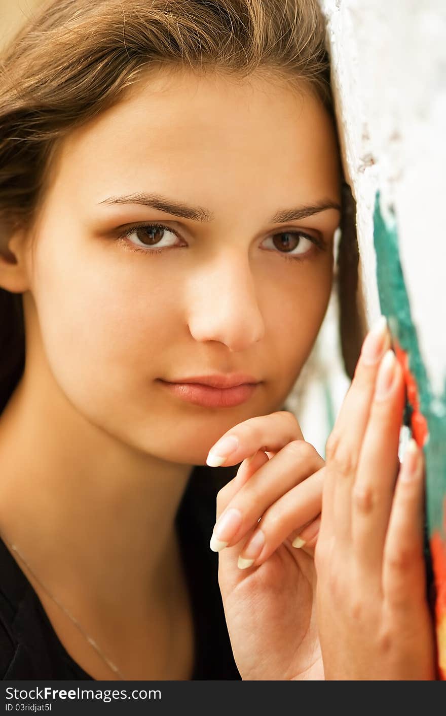 Young woman against wall with graffiti