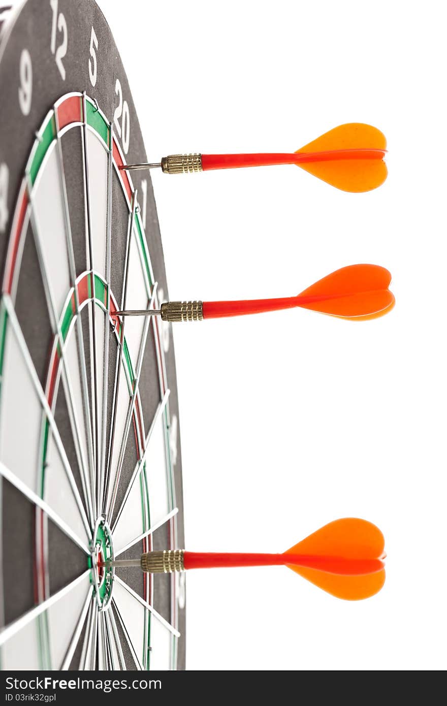 Shallow depth of field shot of darts in bullseye on dartboard. Shallow depth of field shot of darts in bullseye on dartboard