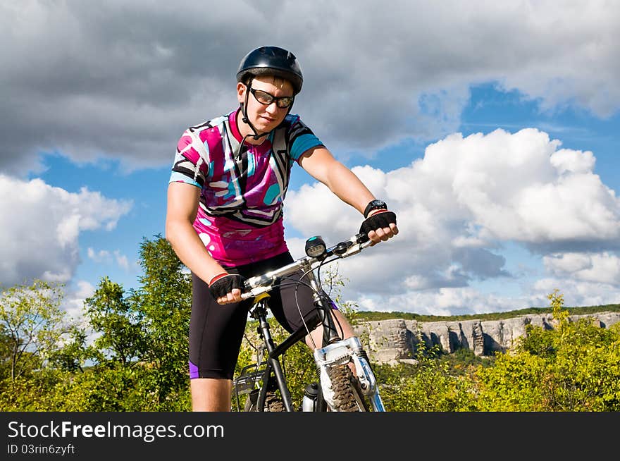 Young sportive man with his black muontain-bike. Young sportive man with his black muontain-bike