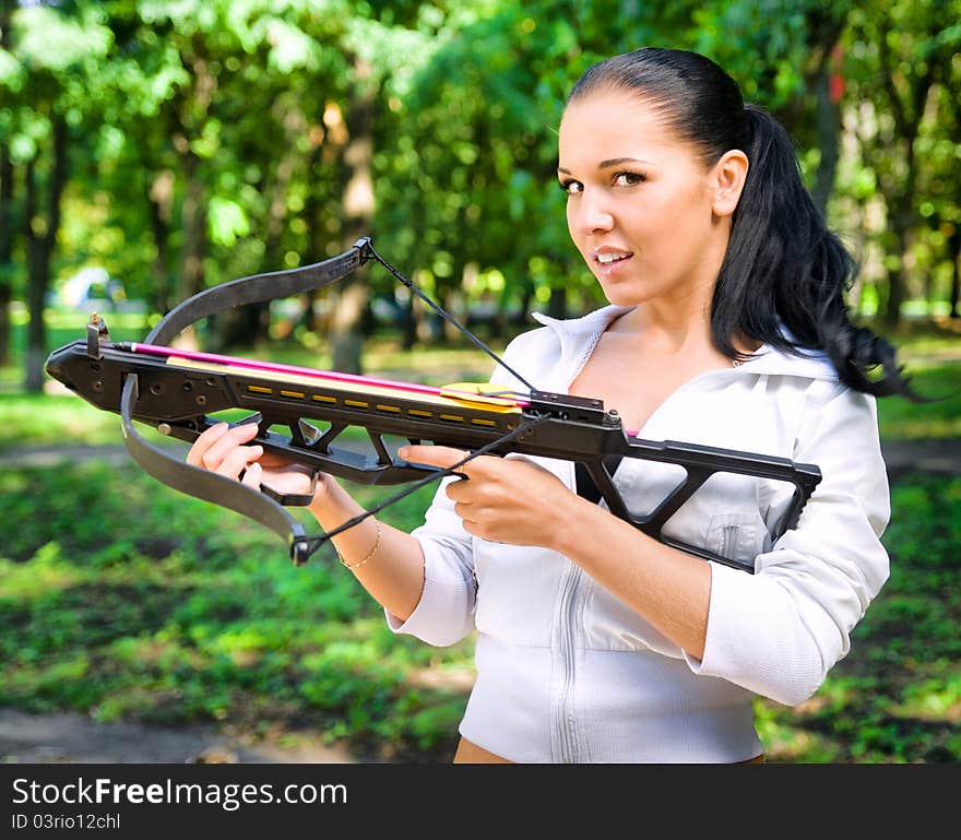 Beautiful young girl with arbalest