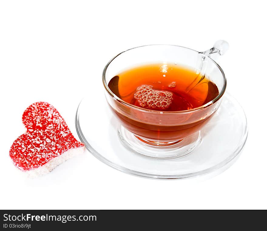 Mugs of coffee with sweet heart on white background