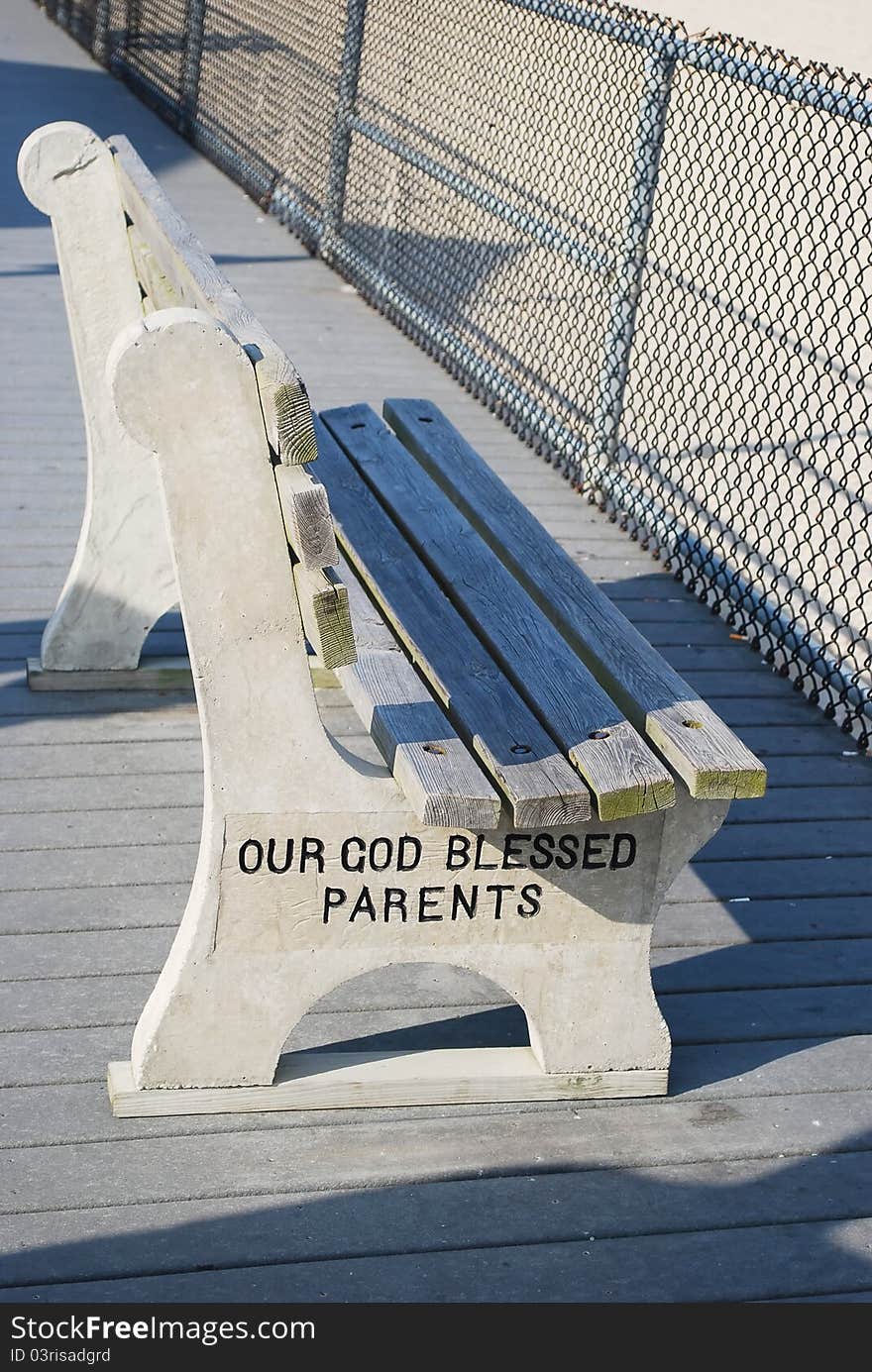 Old Bench on a street in NJ coast with worlds our God bless parents.