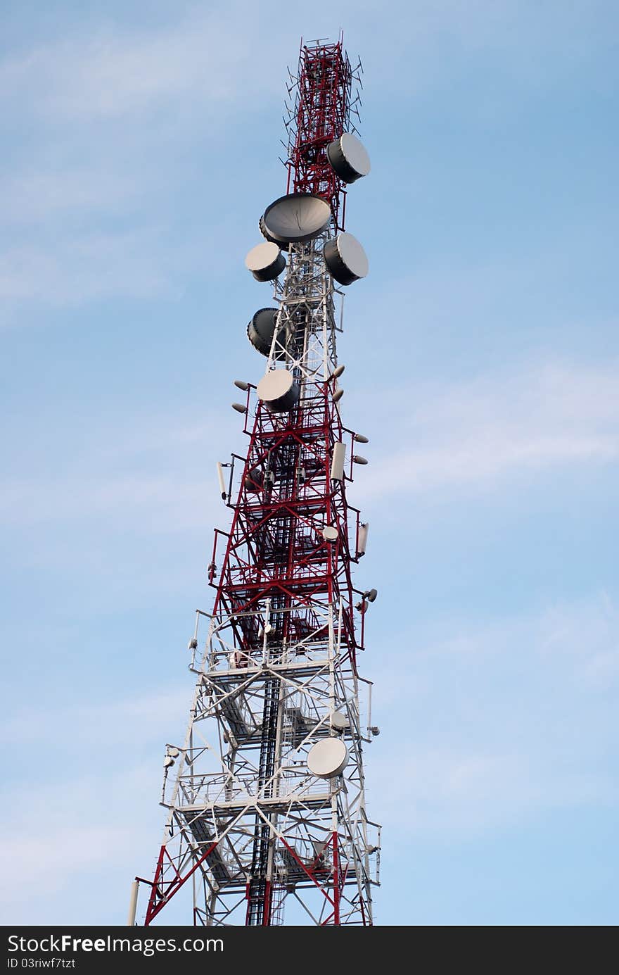 Big red & white antenna on blue sky. Big red & white antenna on blue sky