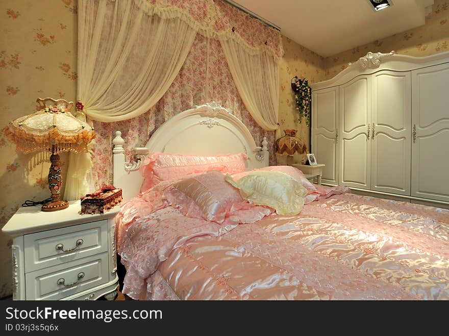 Flowery and pink color bedding and furniture in bedroom, elegance and fine style for female. Flowery and pink color bedding and furniture in bedroom, elegance and fine style for female.