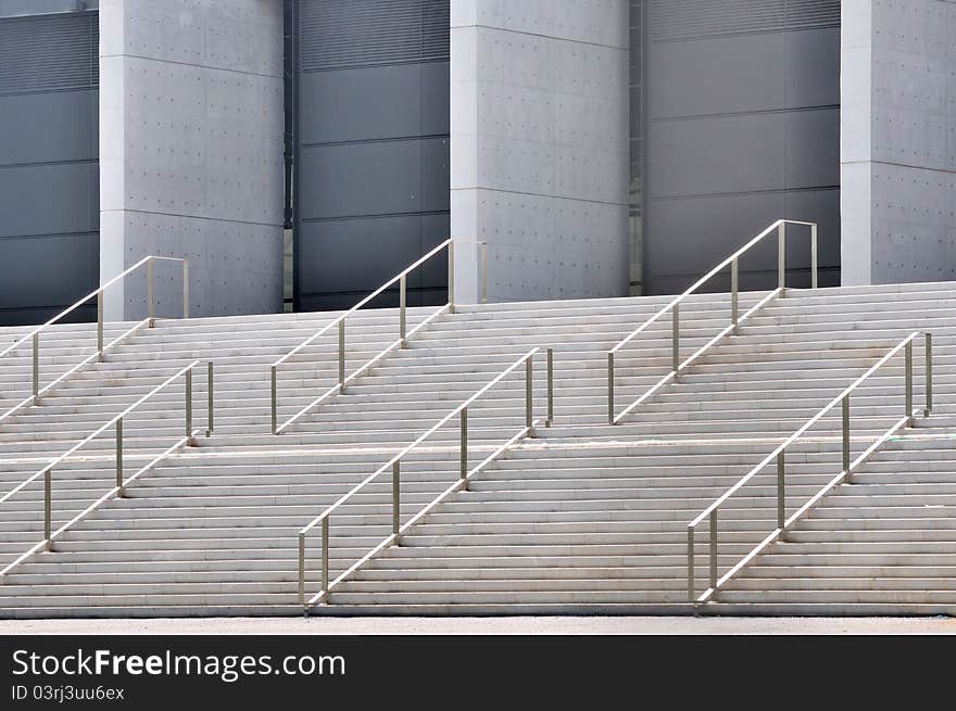 Concrete platform stage with metal handrail in repeated pattern and design, shown as industrial architecture or featured pattern and texture. Concrete platform stage with metal handrail in repeated pattern and design, shown as industrial architecture or featured pattern and texture.