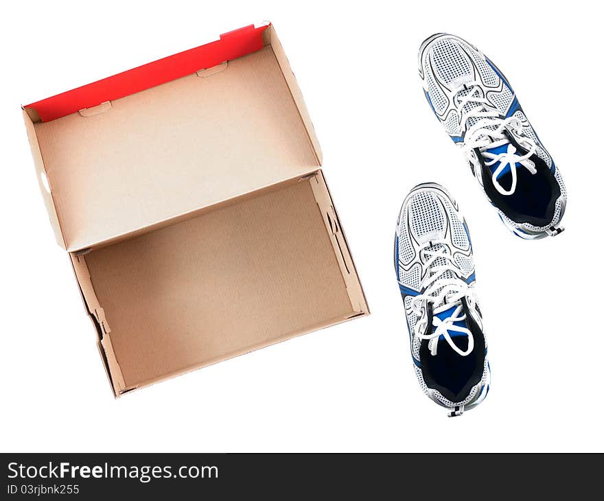 Sports runners situated next to a shoe box