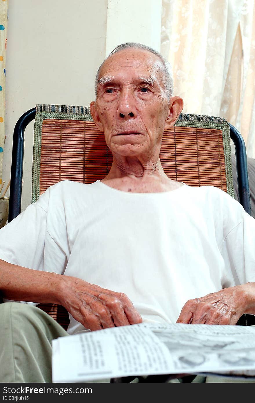 The Old Serious Chinese people who Sitting in Chair. The Old Serious Chinese people who Sitting in Chair