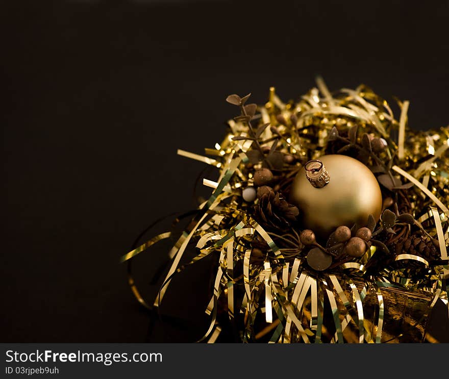 Golden christmas ball on black backround