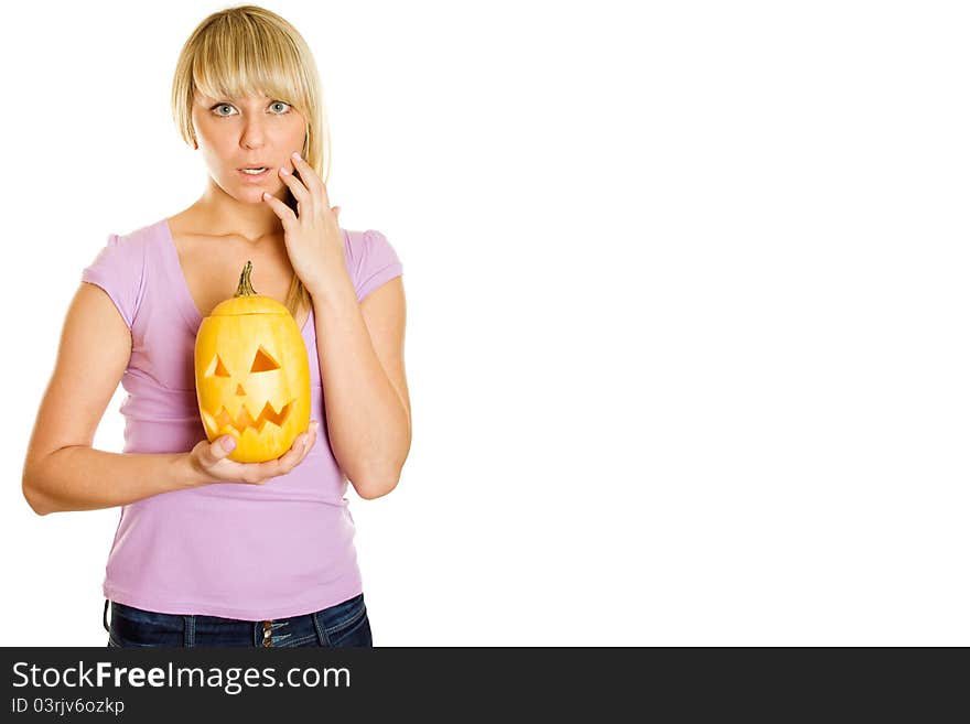 Young woman frightened with pumpkin for Halloween. Lots of copyspace and room for text on this isolate. Young woman frightened with pumpkin for Halloween. Lots of copyspace and room for text on this isolate