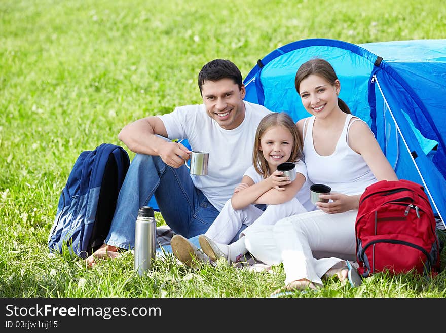 A happy family with a tent. A happy family with a tent