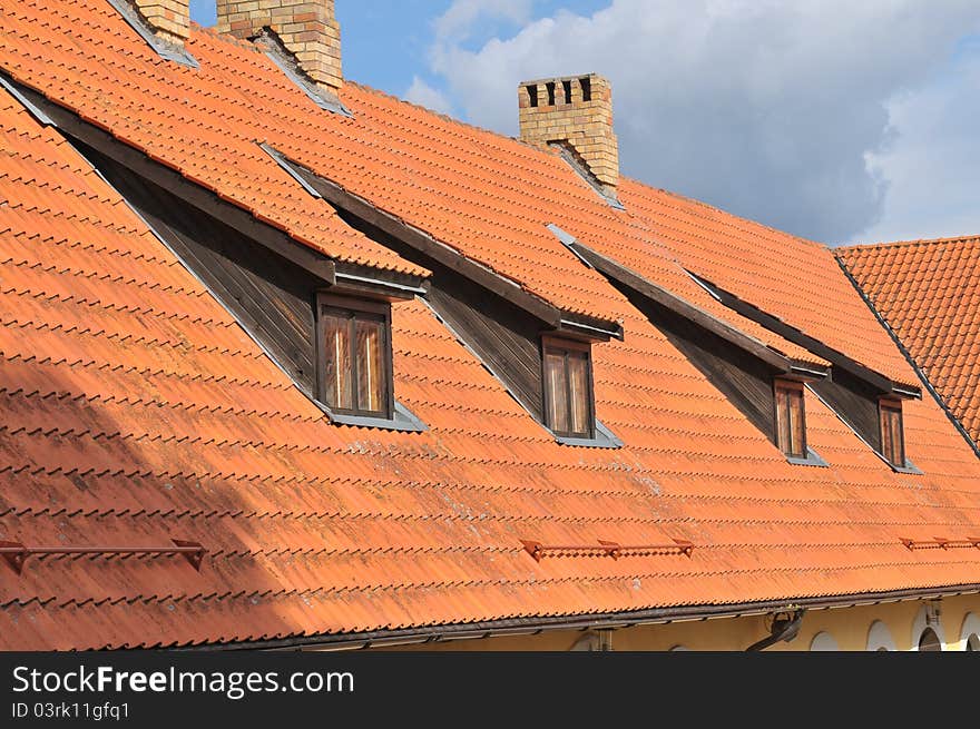 Four windows on the tile roof