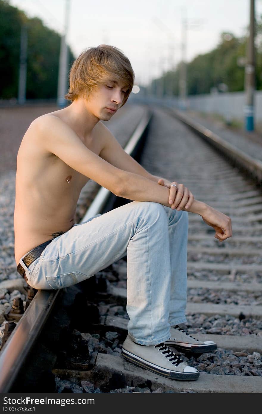 Handsome man walking near rails