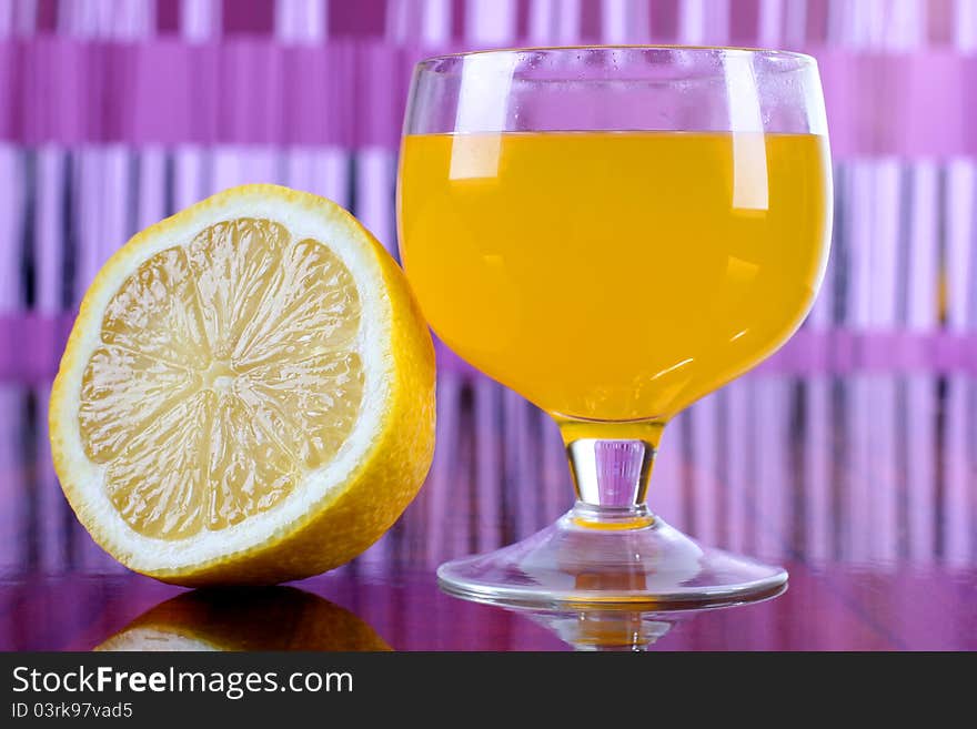 Color photo of a glass cup with a cocktail and lemon. Color photo of a glass cup with a cocktail and lemon