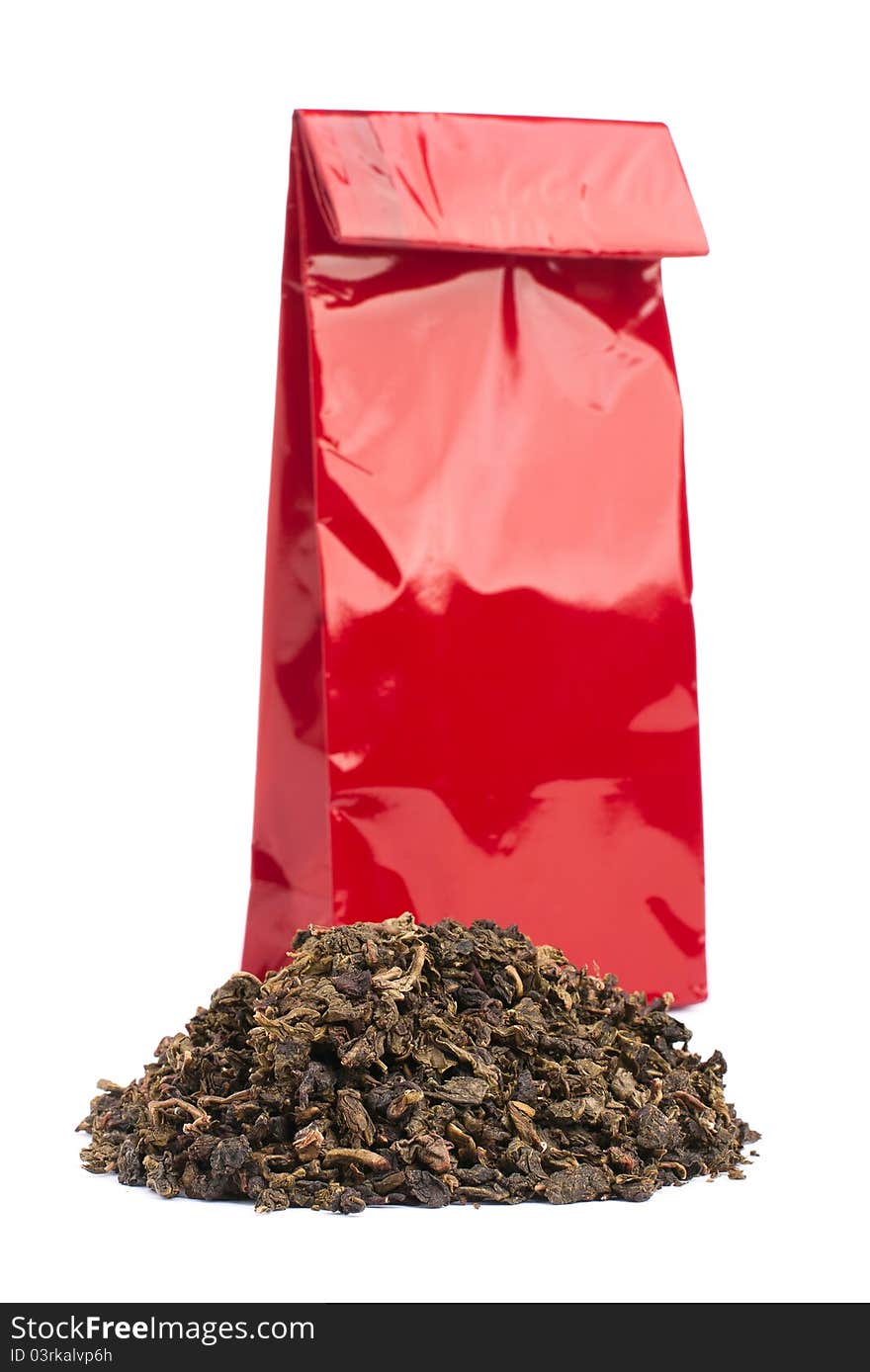 Heap of black tea and tea package