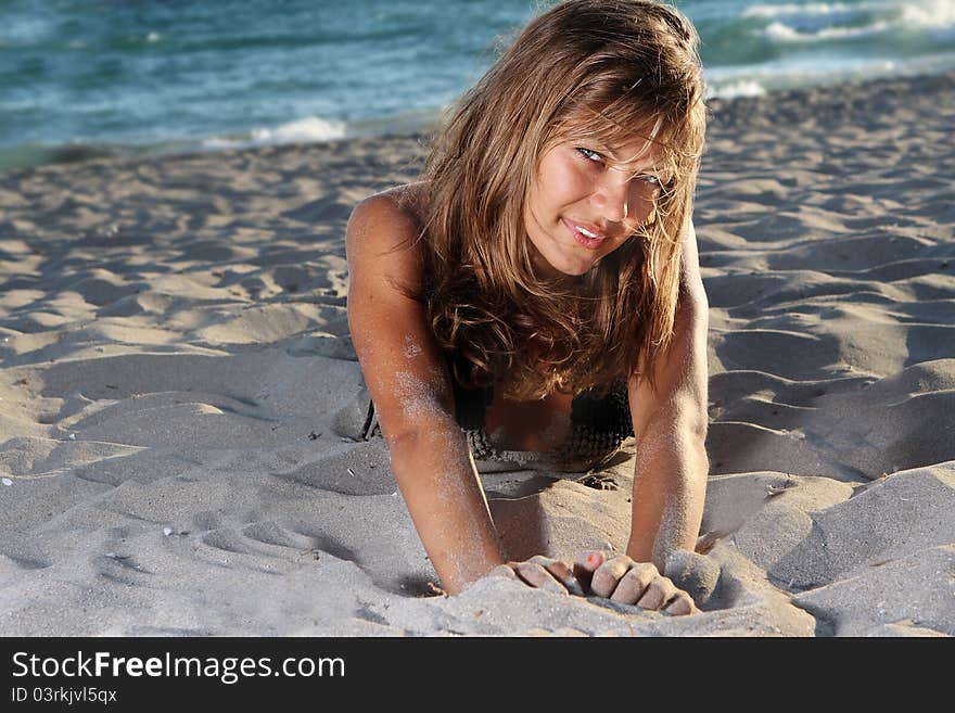 Young Woman In Black Bikini On Sky Background