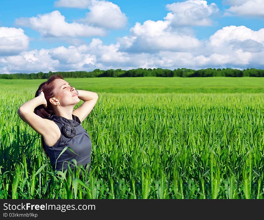 Young woman with hands raised up in the wheat field. Young woman with hands raised up in the wheat field