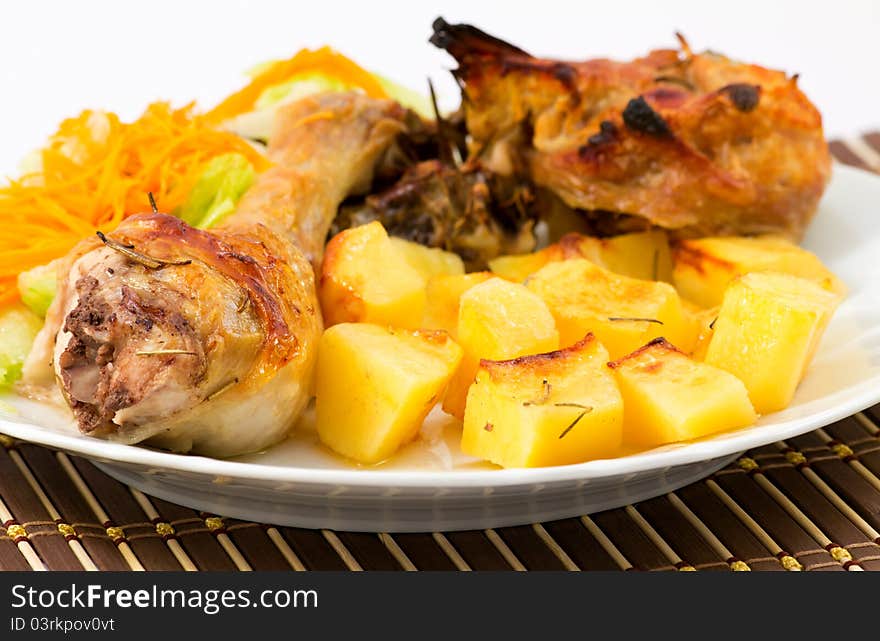 Roast chicken with potatoes and a salad of lettuce and carrots