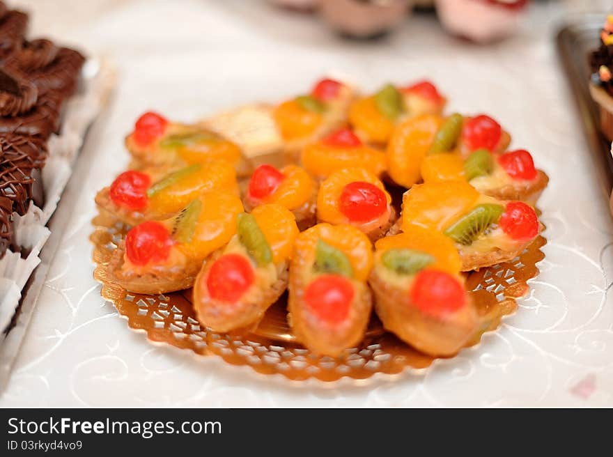 Miniature wedding cakes decorated with cherries