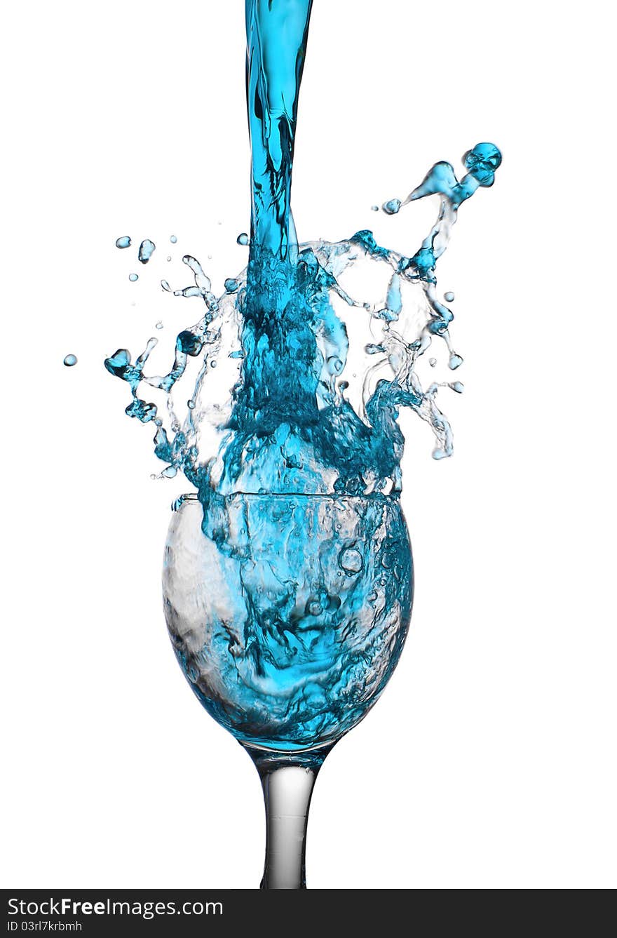 The dark blue liquid flows in a glass. The dark blue liquid flows in a glass