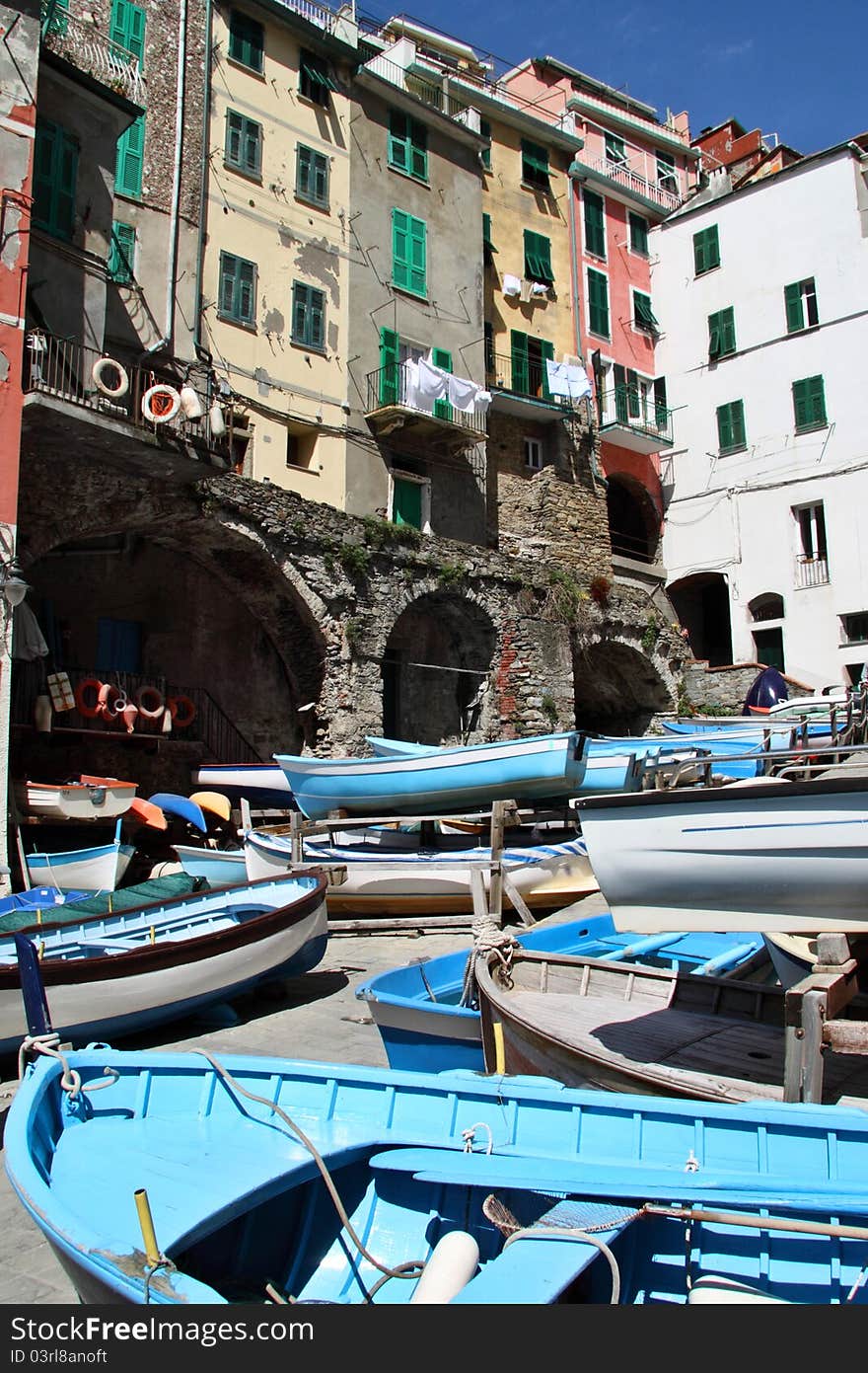 Colorful fishing boats in a small marina in one of the picturesque towns in Cinque Terre region in Ligurian coast. Colorful fishing boats in a small marina in one of the picturesque towns in Cinque Terre region in Ligurian coast.