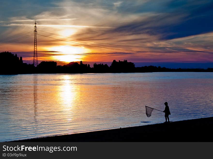 Boy fishing on a riverside. Boy fishing on a riverside