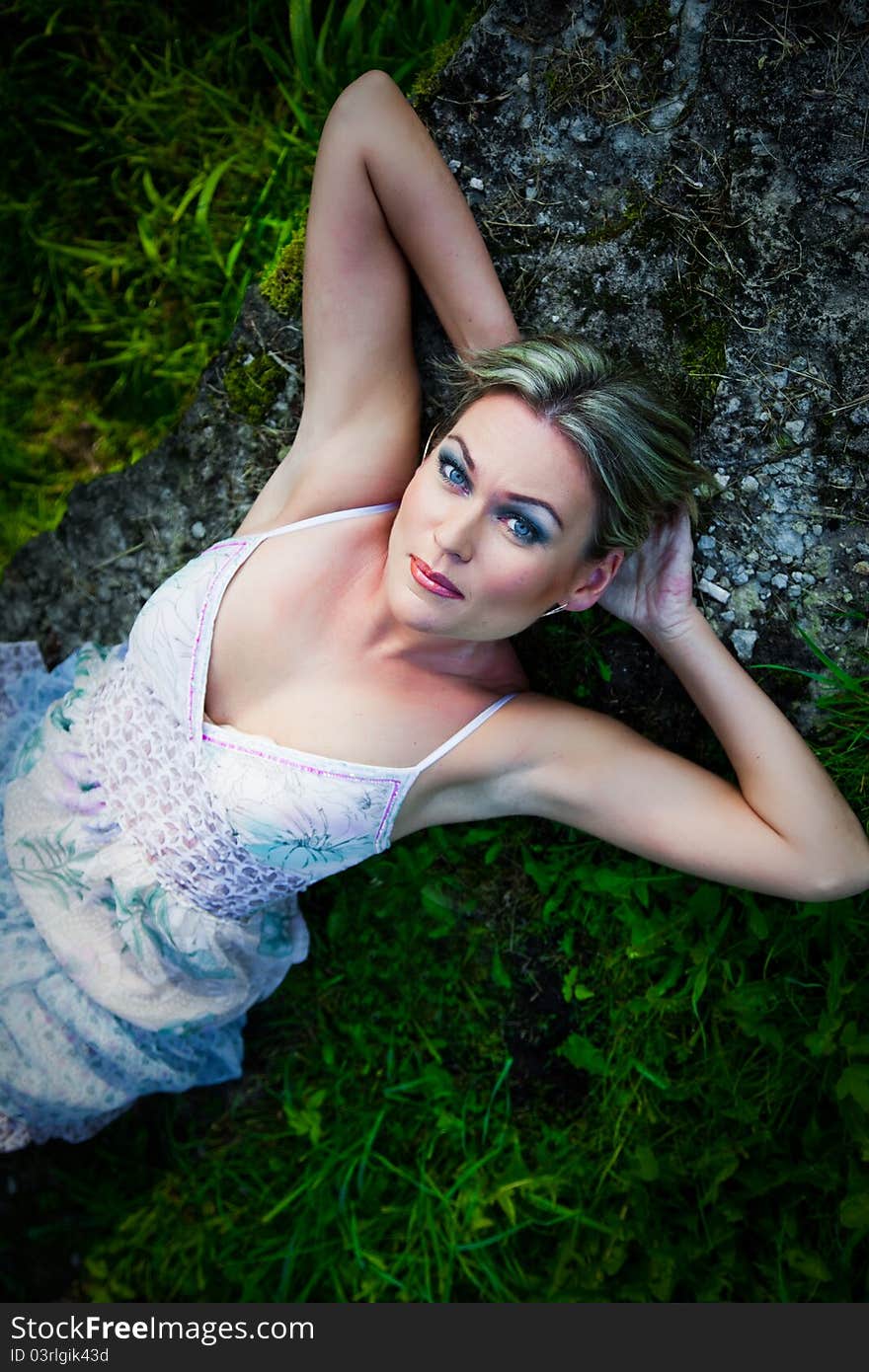 Attractive woman lying on stones