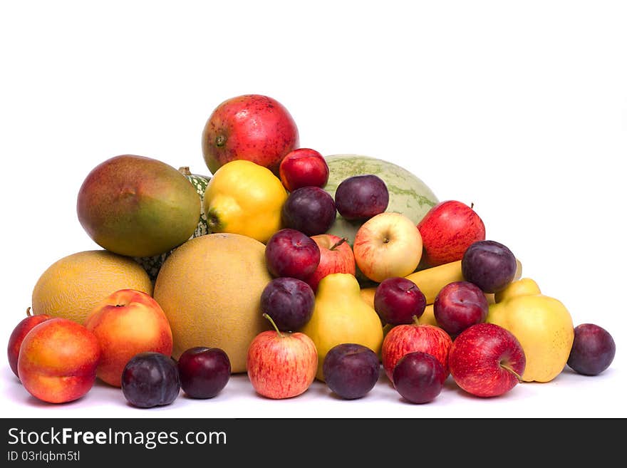 Close up view of a pile of fresh variety of fruits isolated on a white background. Close up view of a pile of fresh variety of fruits isolated on a white background.