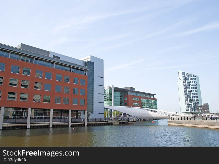 A Dockside Redevelopment showing modern offices and a modern white footbridge. A Dockside Redevelopment showing modern offices and a modern white footbridge