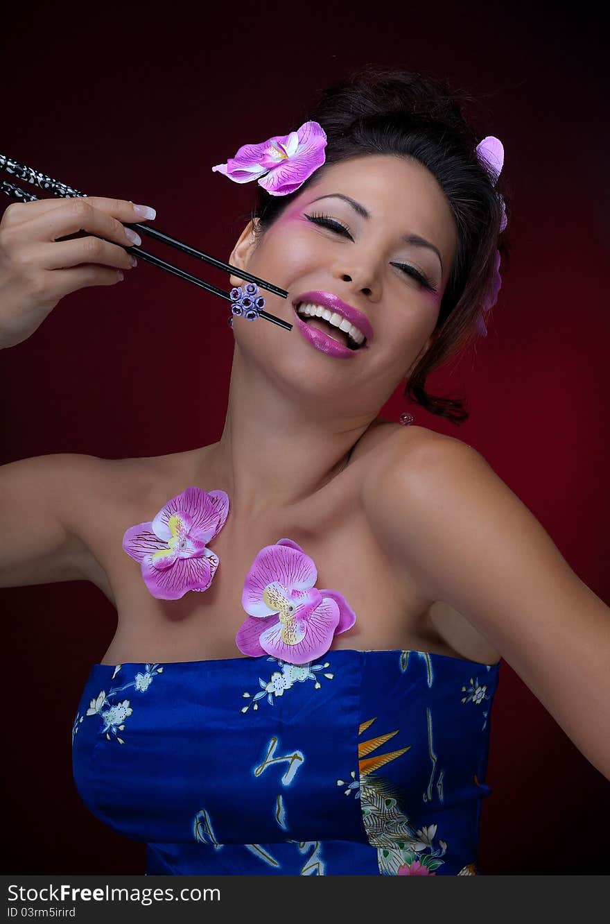 Portrait of young gorgeous asian woman with chopsticks. Portrait of young gorgeous asian woman with chopsticks