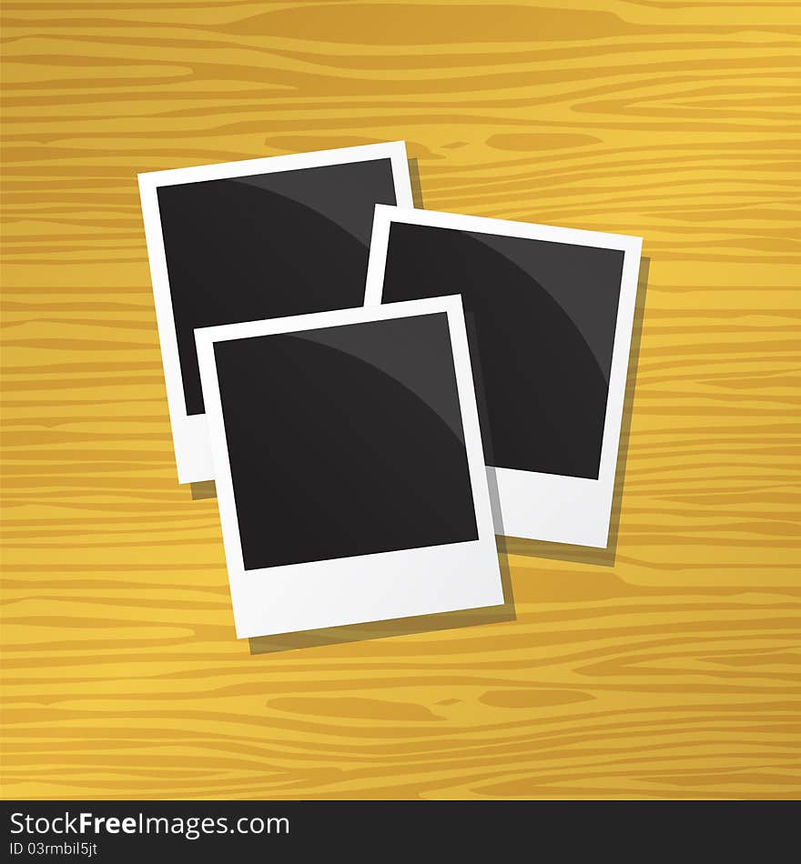 Three blank instant photos on wood background. Three blank instant photos on wood background