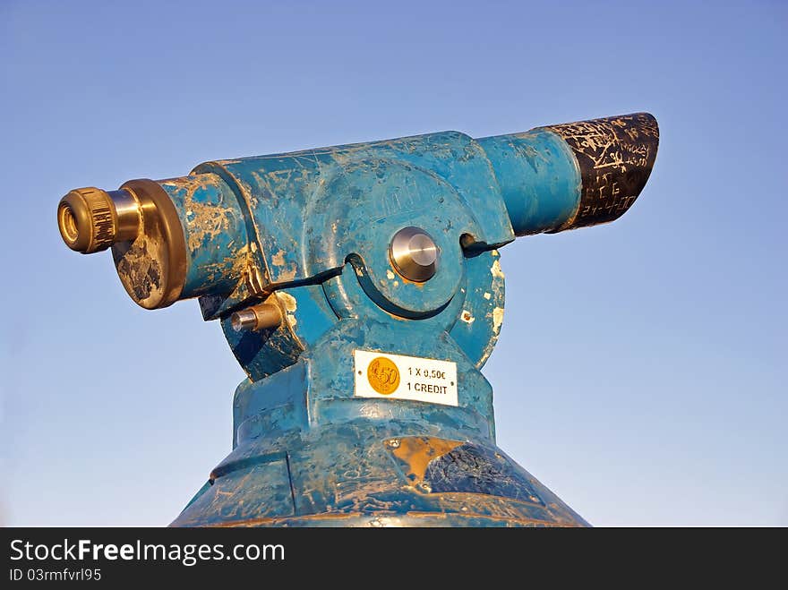 Blue and old coin operated telescope in Spain