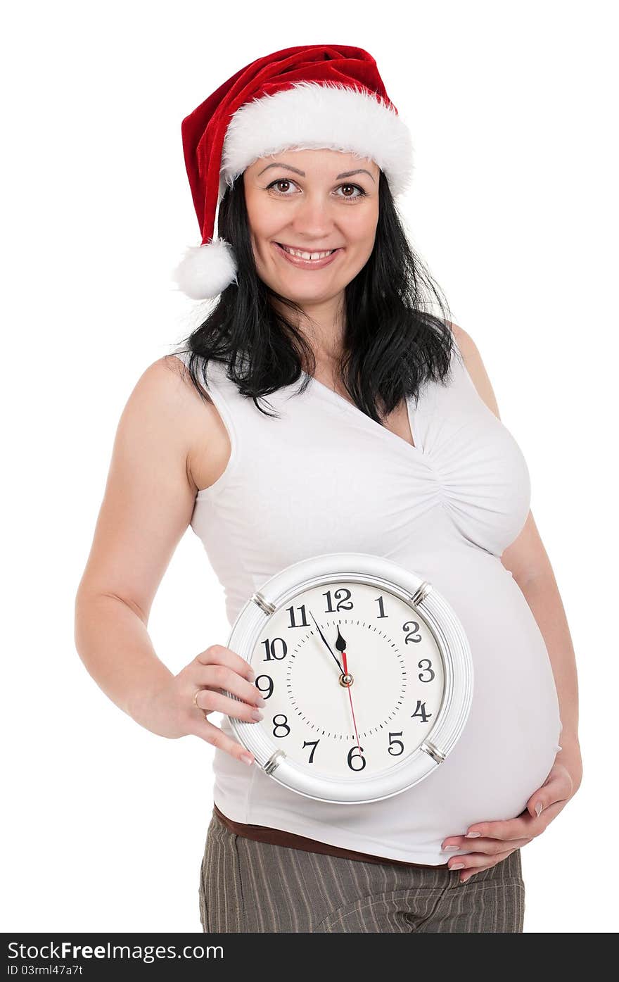 Portrait of a pregnant woman in santa hat with clock over white background. Third trimester. Portrait of a pregnant woman in santa hat with clock over white background. Third trimester.