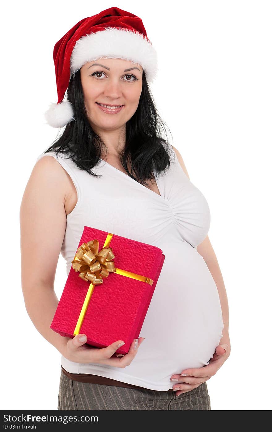 Portrait of a pregnant woman in santa hat with gift box over white background. Third trimester. Portrait of a pregnant woman in santa hat with gift box over white background. Third trimester.