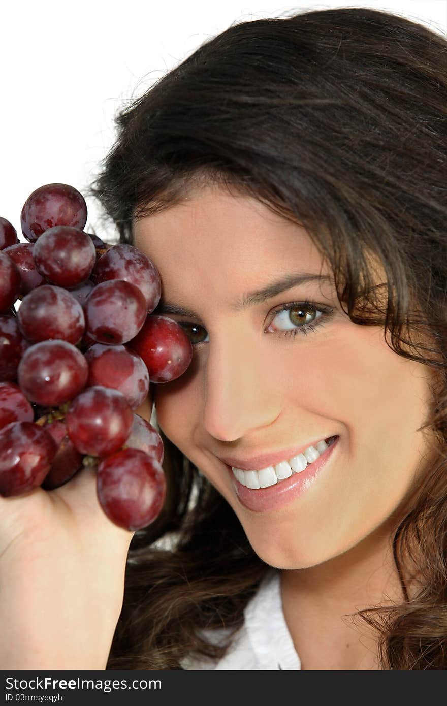 Portrait of a woman with bunch of ripe grapes