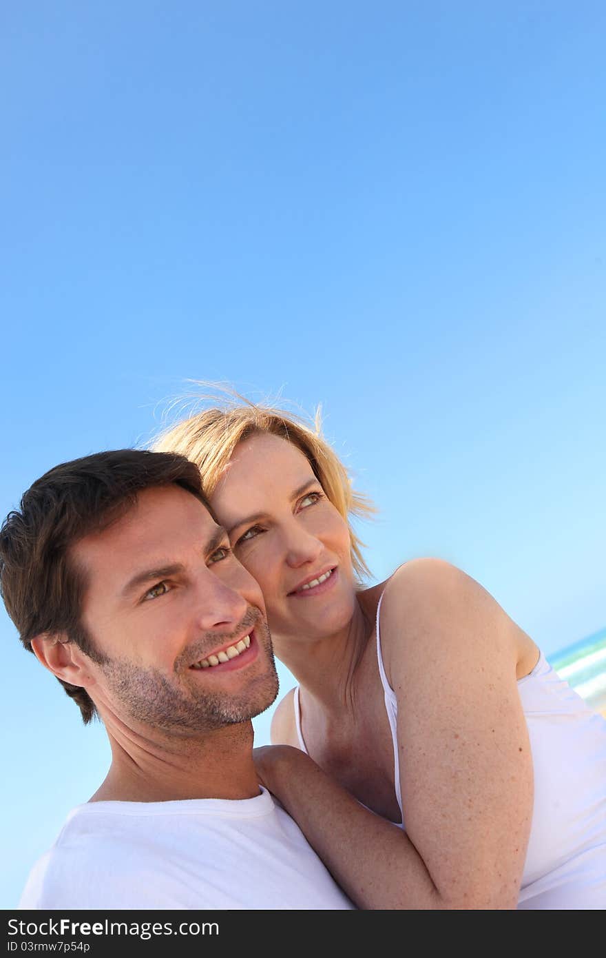 Portrait of a miling couple on the beach