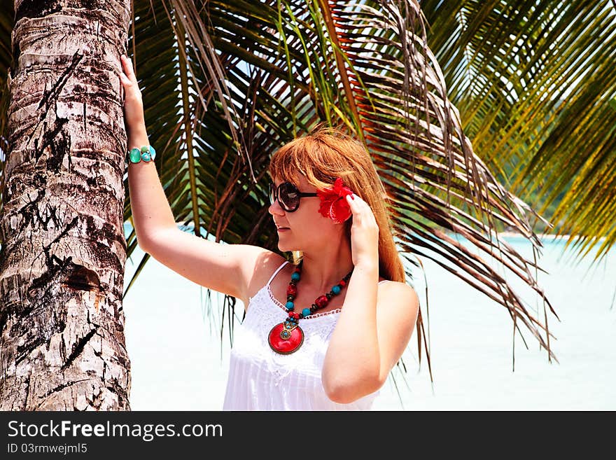 Beautiful Woman Standing Under Palm Tree