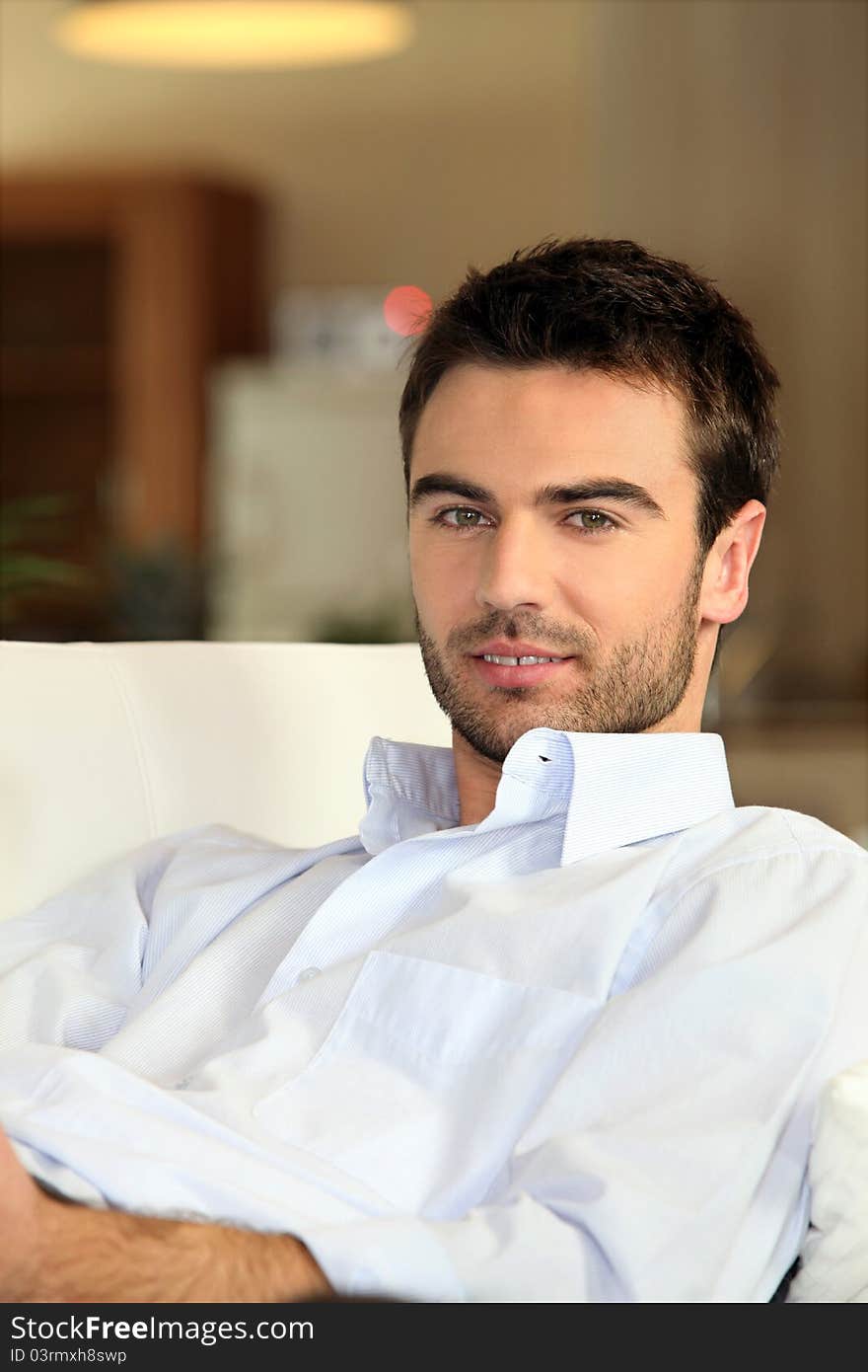 A man reposing in his sofa at home. A man reposing in his sofa at home