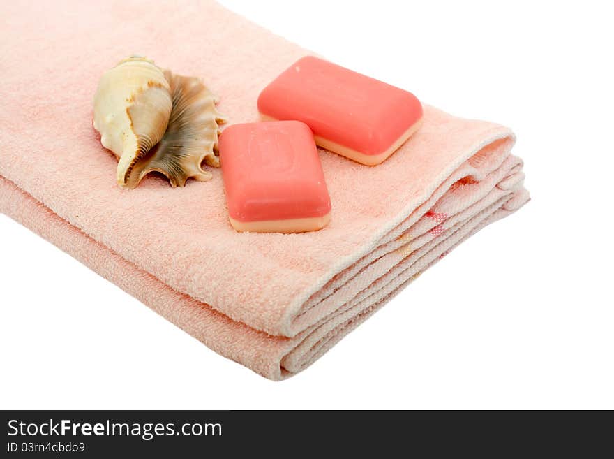 Pink towel and soap with shells isolated on a white background. Pink towel and soap with shells isolated on a white background