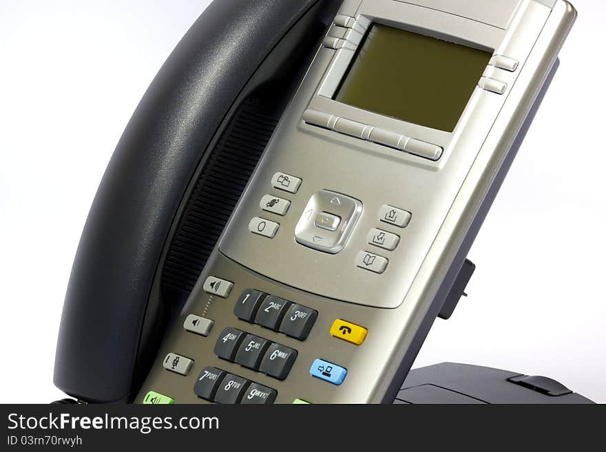 A Modern IP telephone with handset on hook.