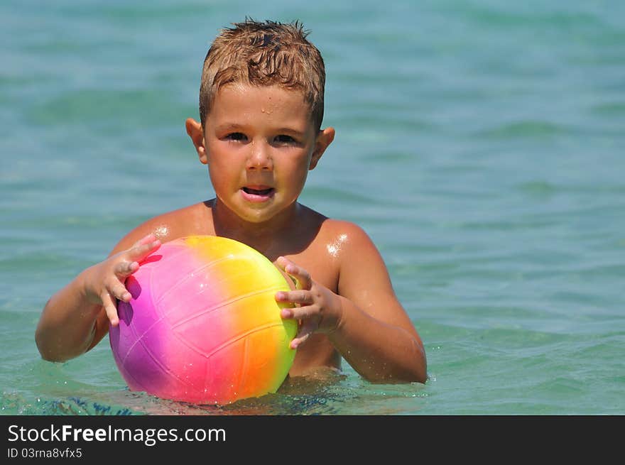 Boy in the water playing with a ball