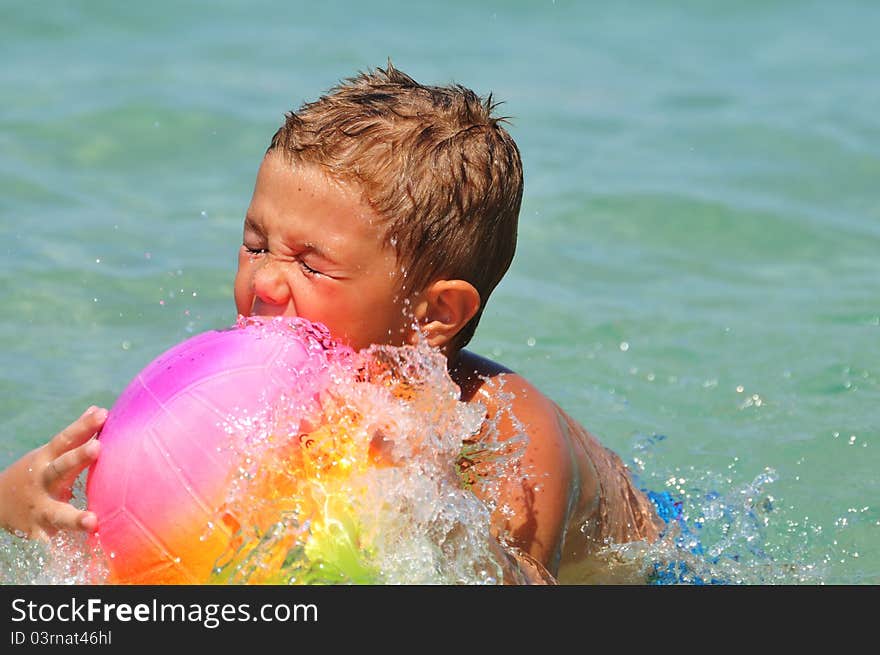 Boy In The Water Playing With A Ball