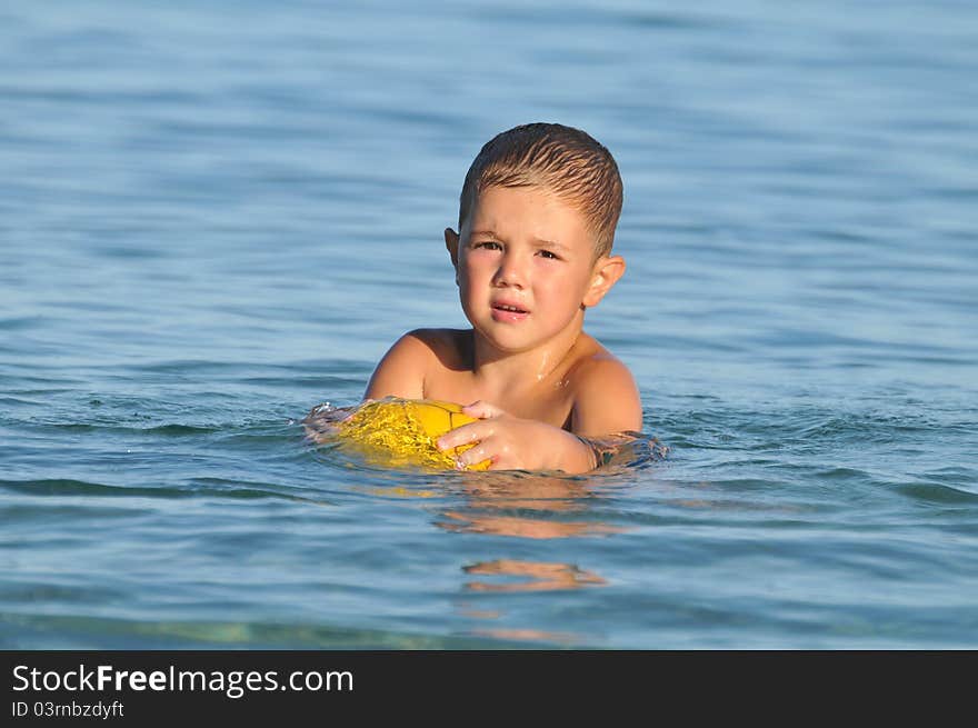 Boy In The Water Playing With A Ball