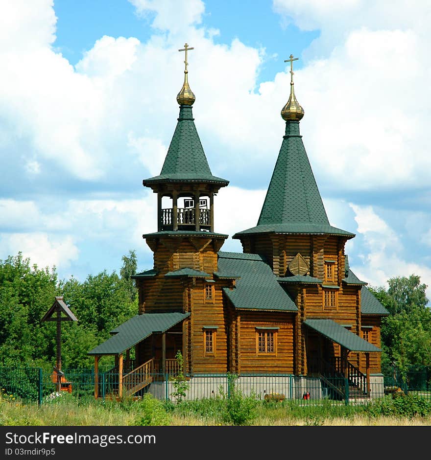 Russian's traditional wooden church with a worship wooden cross.