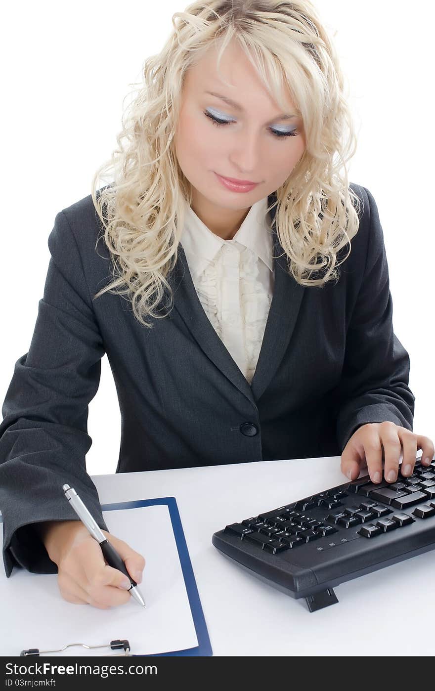 The young girl behind the computer on white