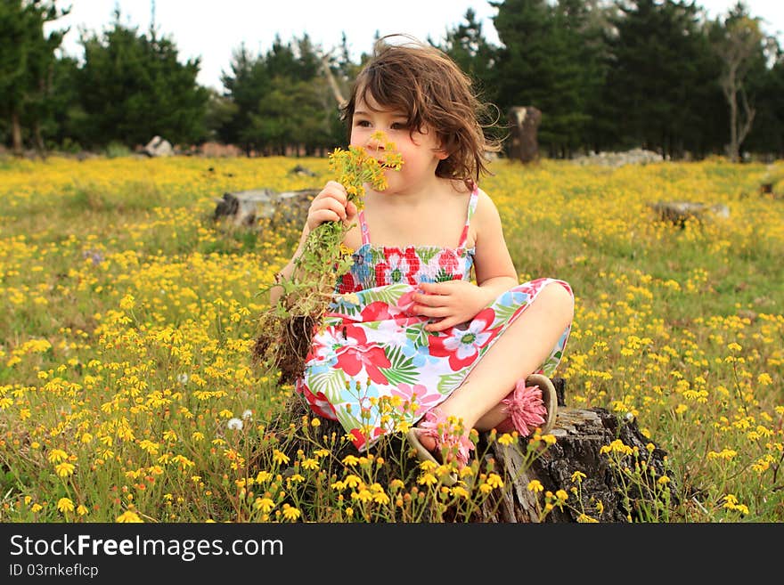 Young girl smelling flowers