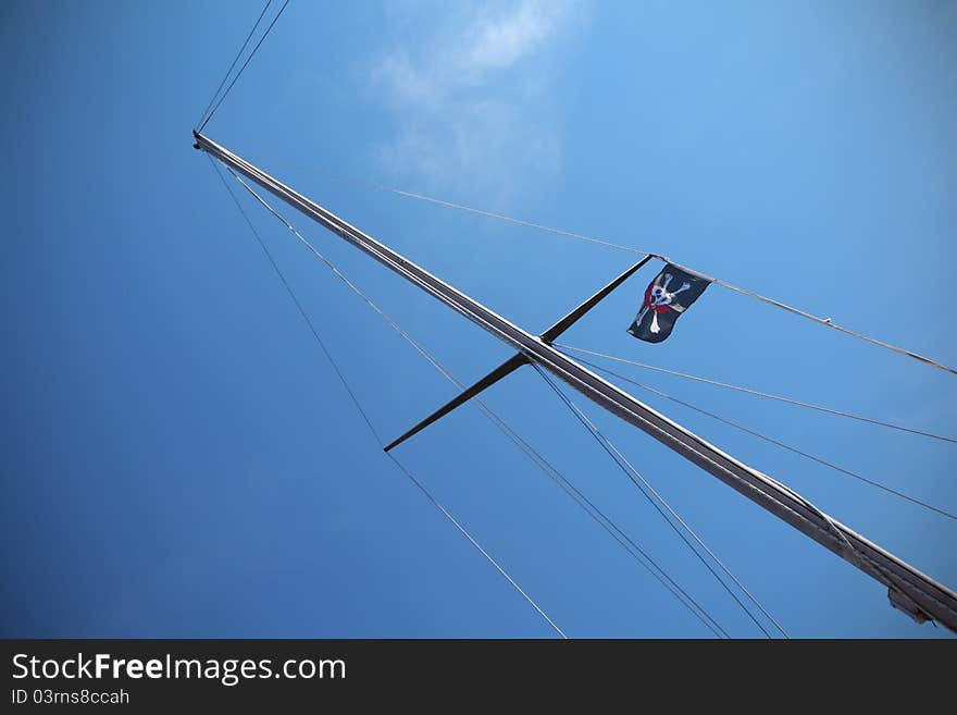 Pirate flag on the ship, sign of piracy on the seas.