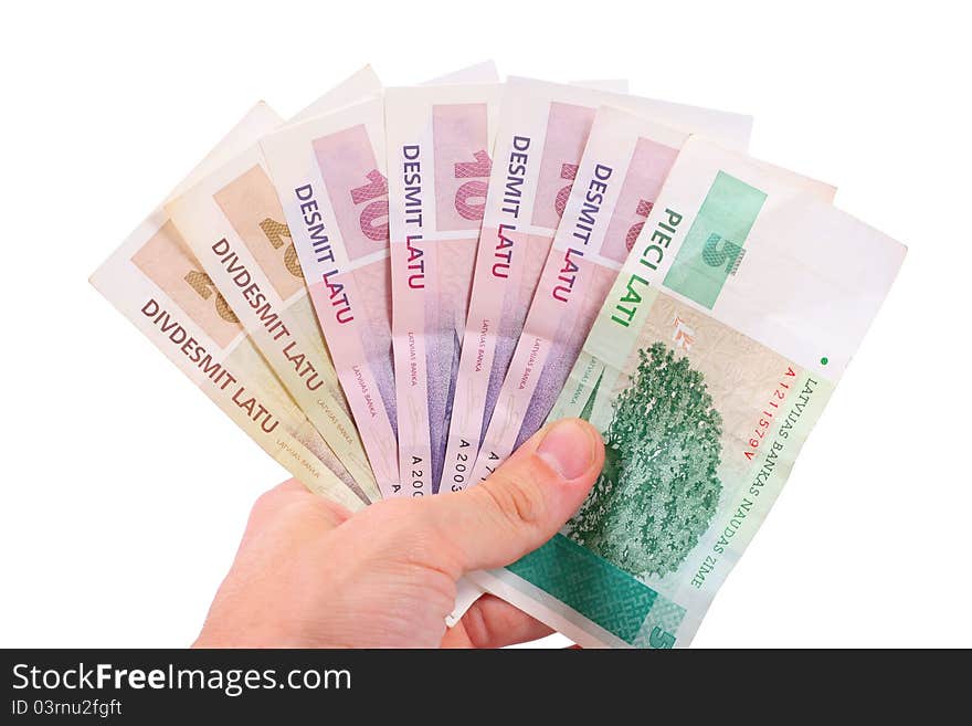 Hand with latvian money isolated on white background